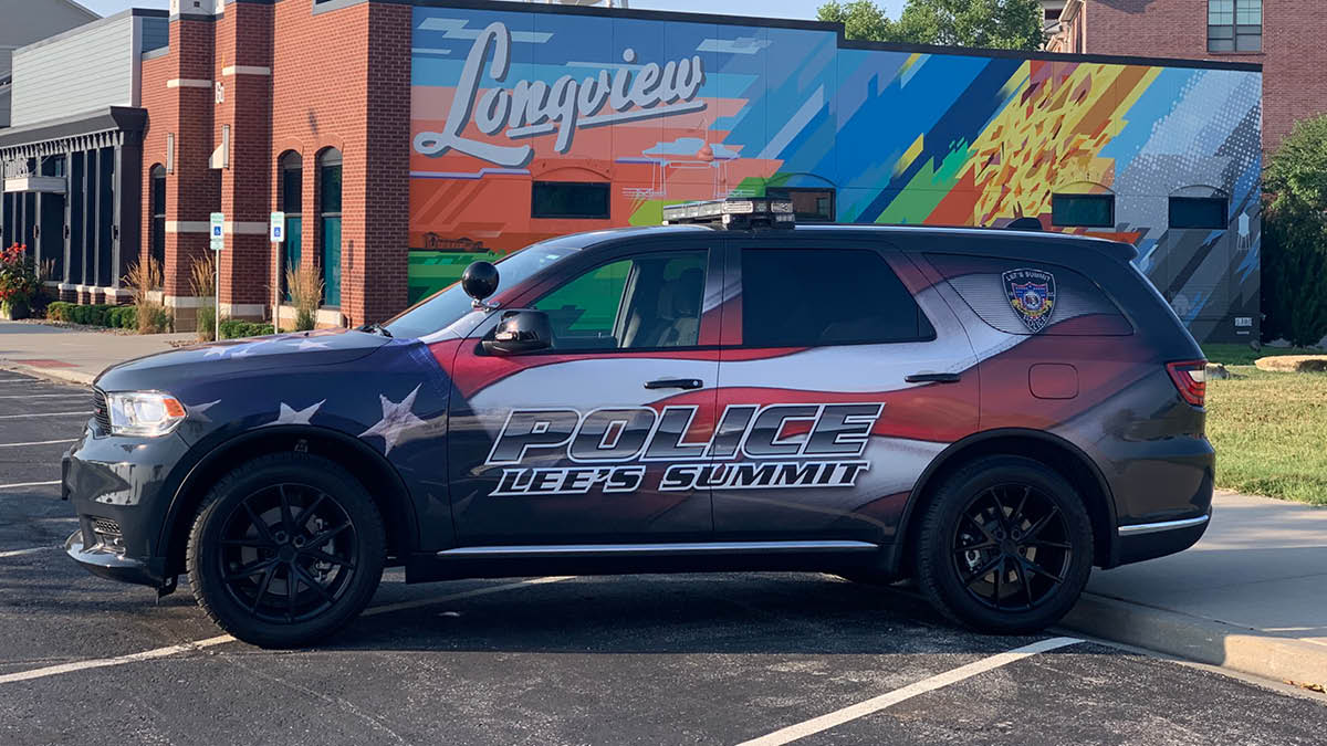 police vehicle in front of Longview mural